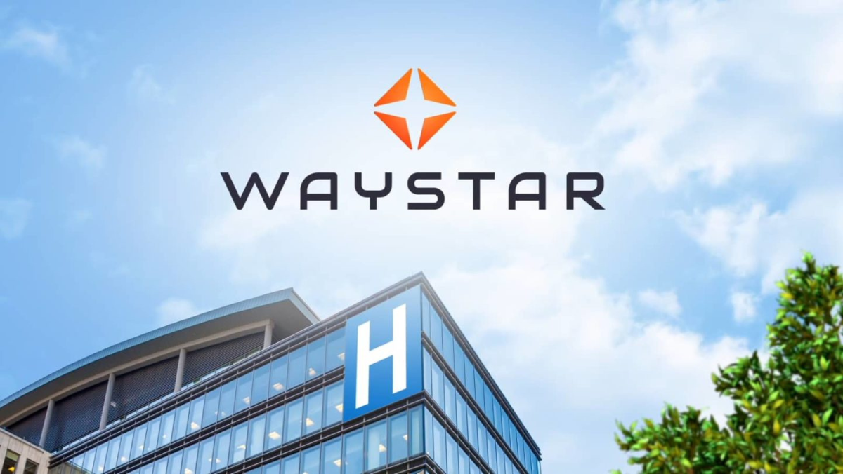 Waystar logo above hospital building symbolizing AI billing partnership with Iodine Software