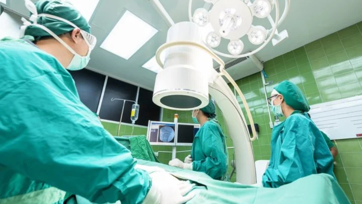 Clinicians operating digital imaging system inside a modern surgical room