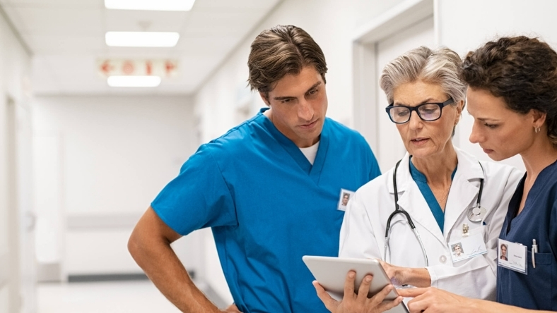 Clinicians reviewing digital health data on hospital tablet